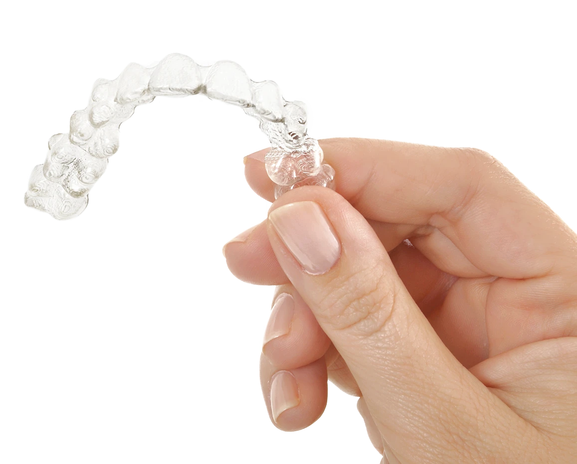 Clear dental aligner held in hand — clear aligner care at ORA Dental Wellness in Bahria Town Phase 4, Rawalpindi